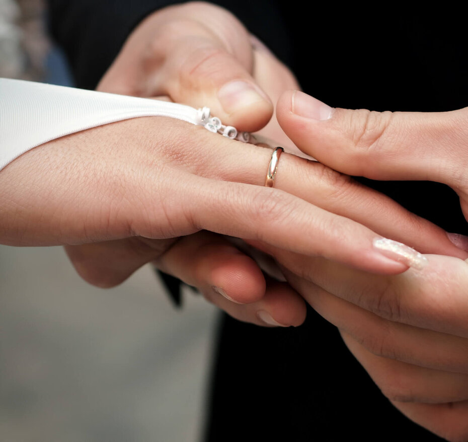 Bräutigam steckt der Braut den Ehering an den Finger
